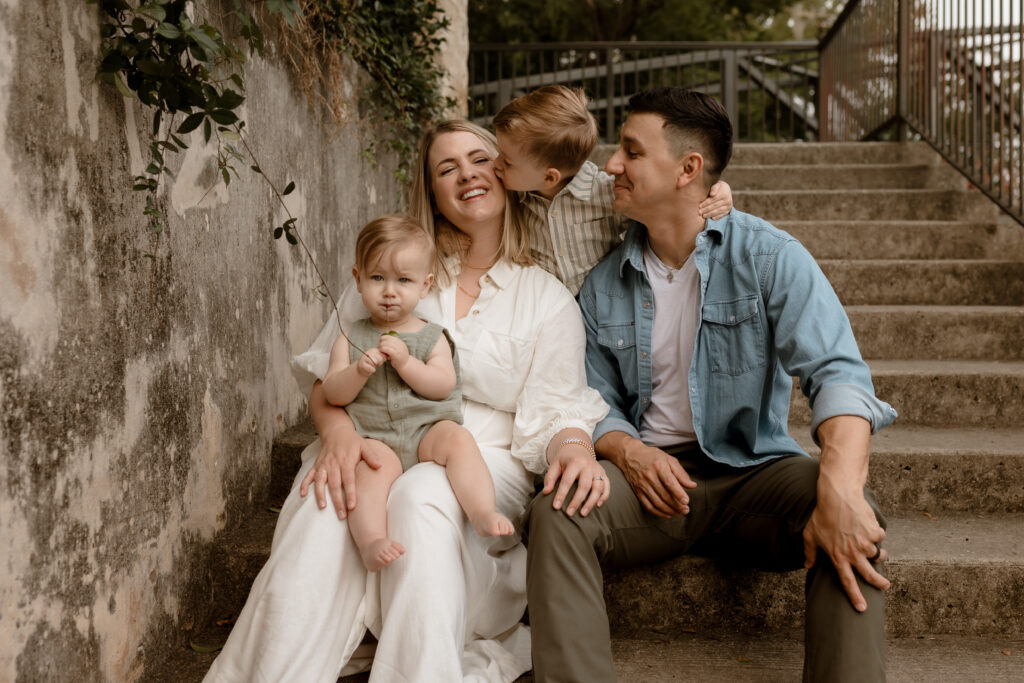 family of four sitting on steps during sunrise photo session