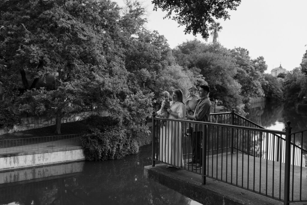 black and white image of family overlooking San Antonio River