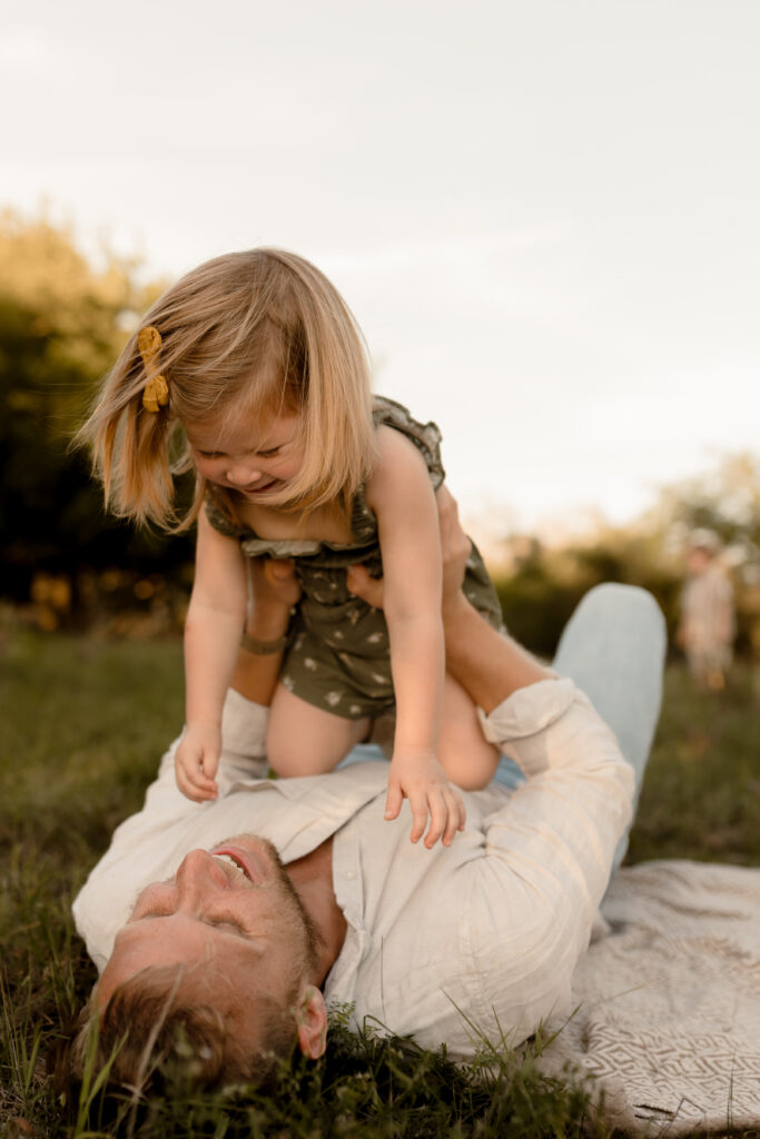 dad playing with little girl