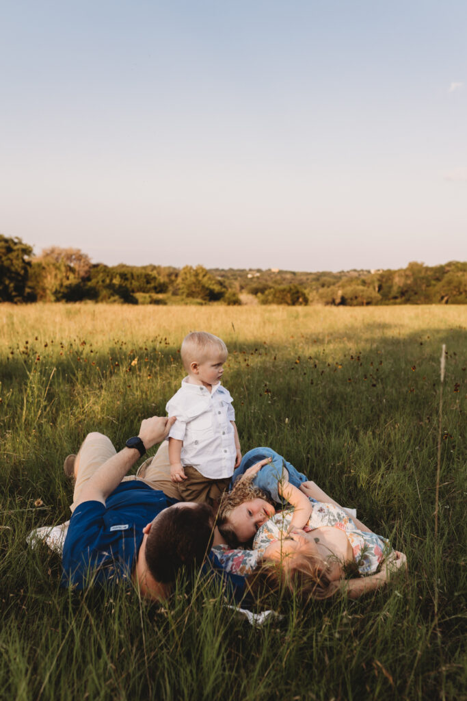 family lying in grass