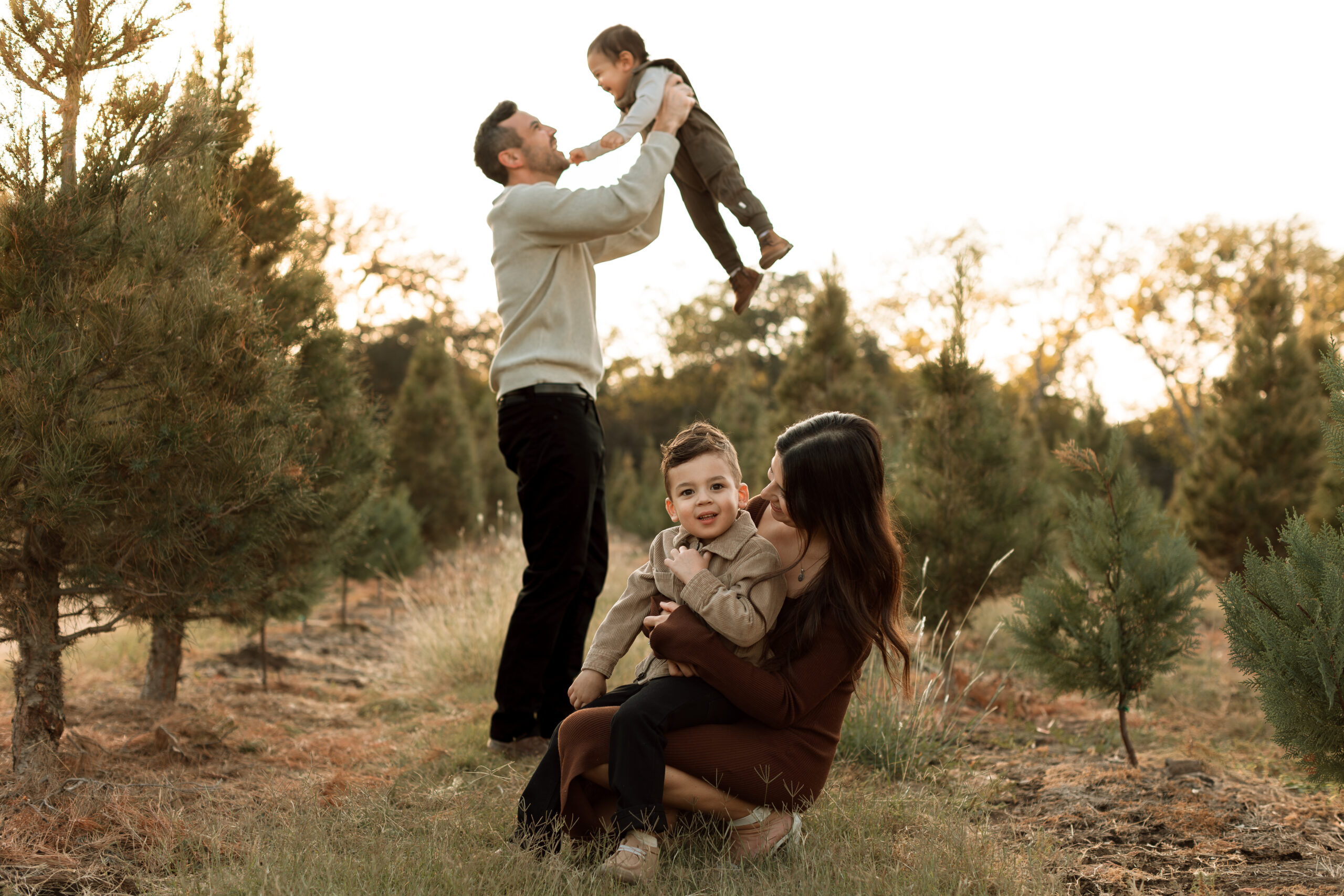 family of four at a tree farm for fall family photos