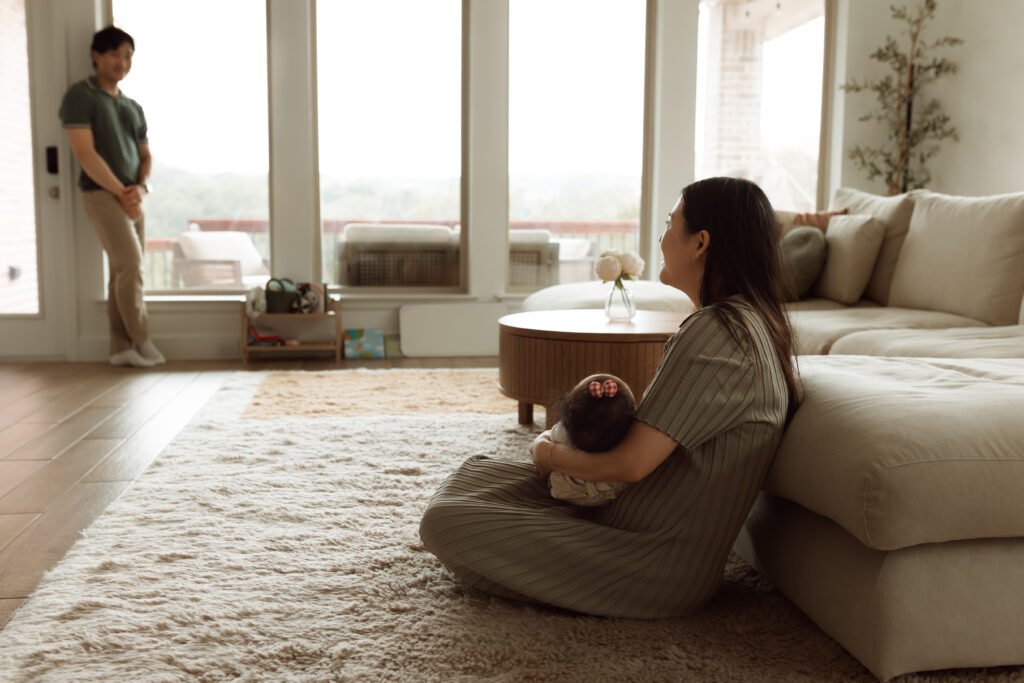 mom holding baby in her home
