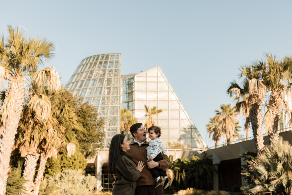 family of three at botanical gardens