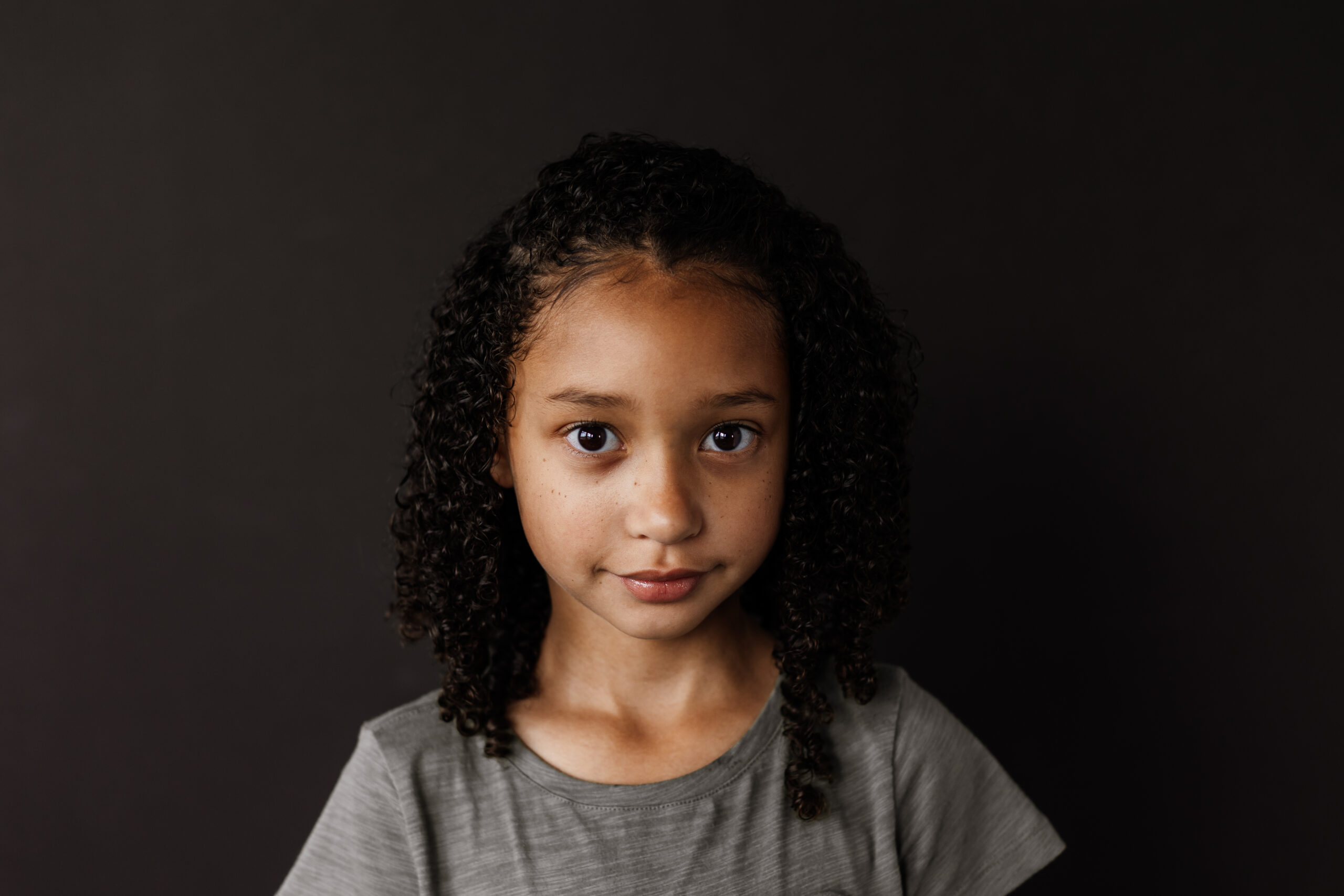 young girl gently smiling for a fine art school photo